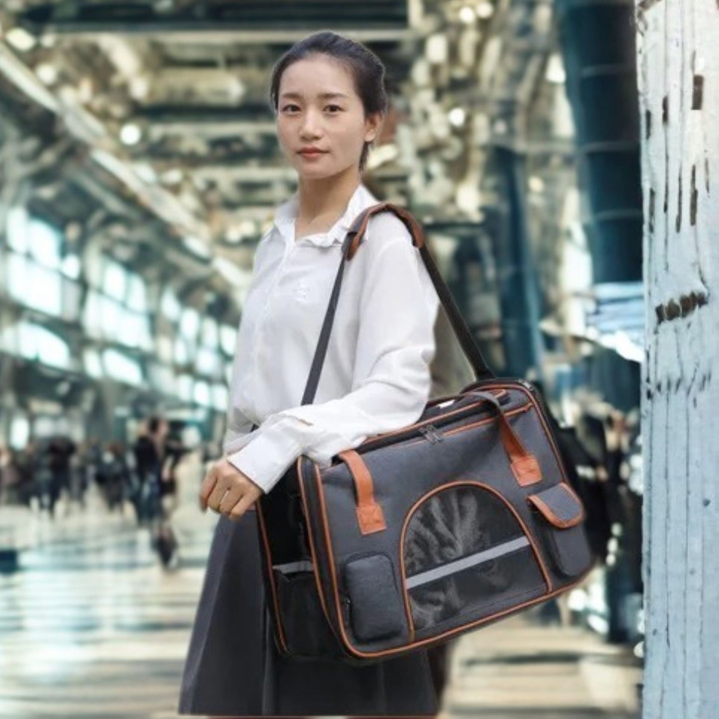 Femme avec son sac de transport pour chien à l'épaule dans un aéroport