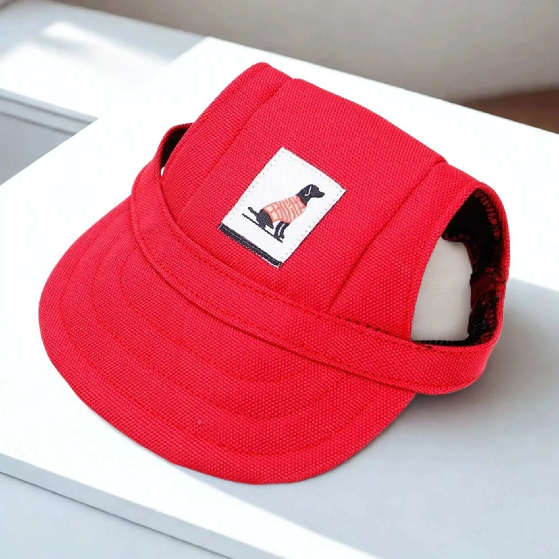 Une casquette chien rouge sur un bureau blanc.