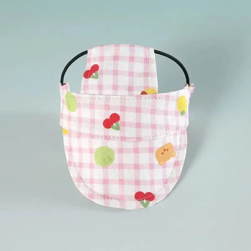 Casquettes pour chien rose et blanc avec motif de cerise.