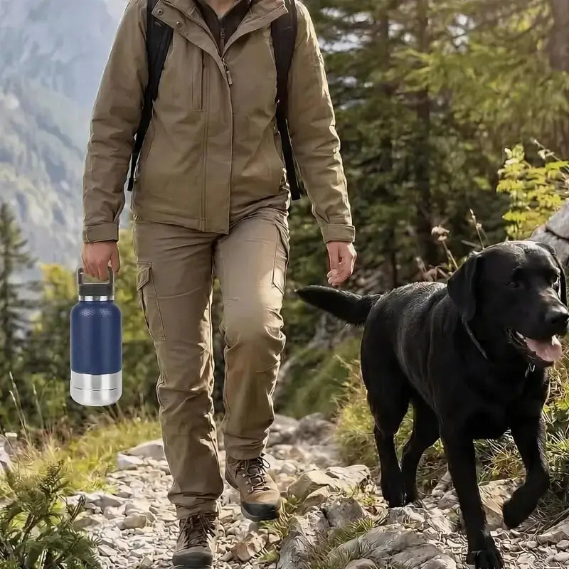 Un individu en randonnée avec son labrador et une gourde pour chien bleue.