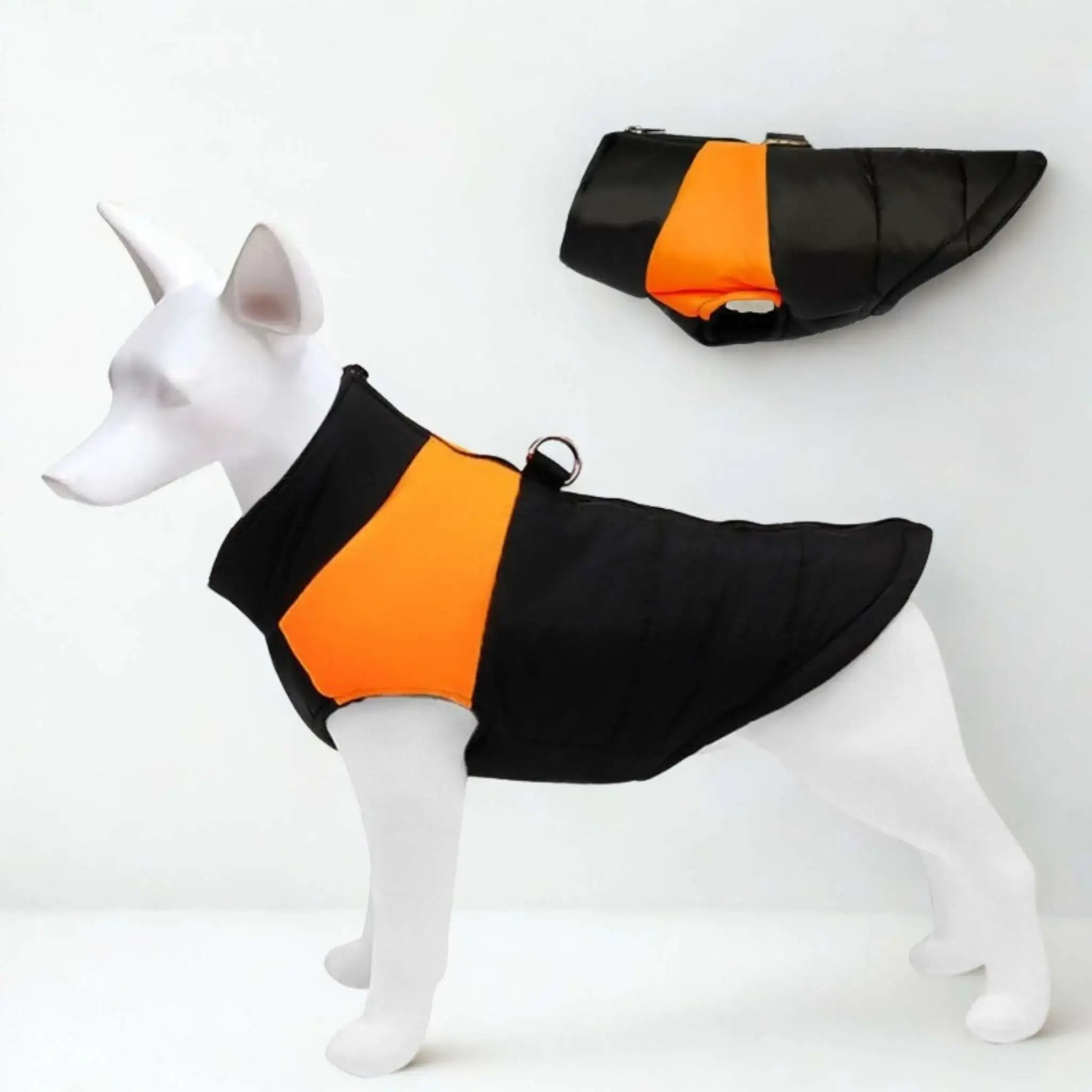 Un modèle vêtu d'un manteau pour chien de couleur orange et noir.