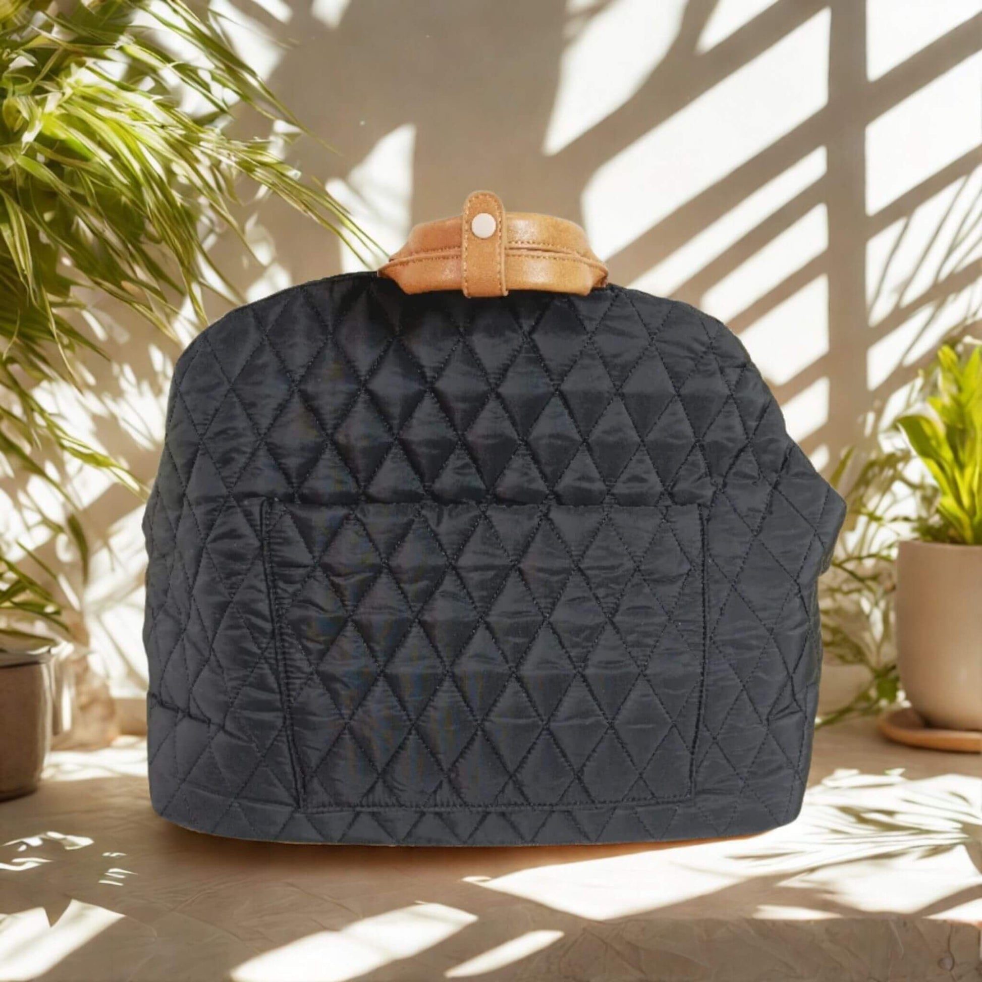 Sac de transport pour chien noir avec plante verte de chaque côté 